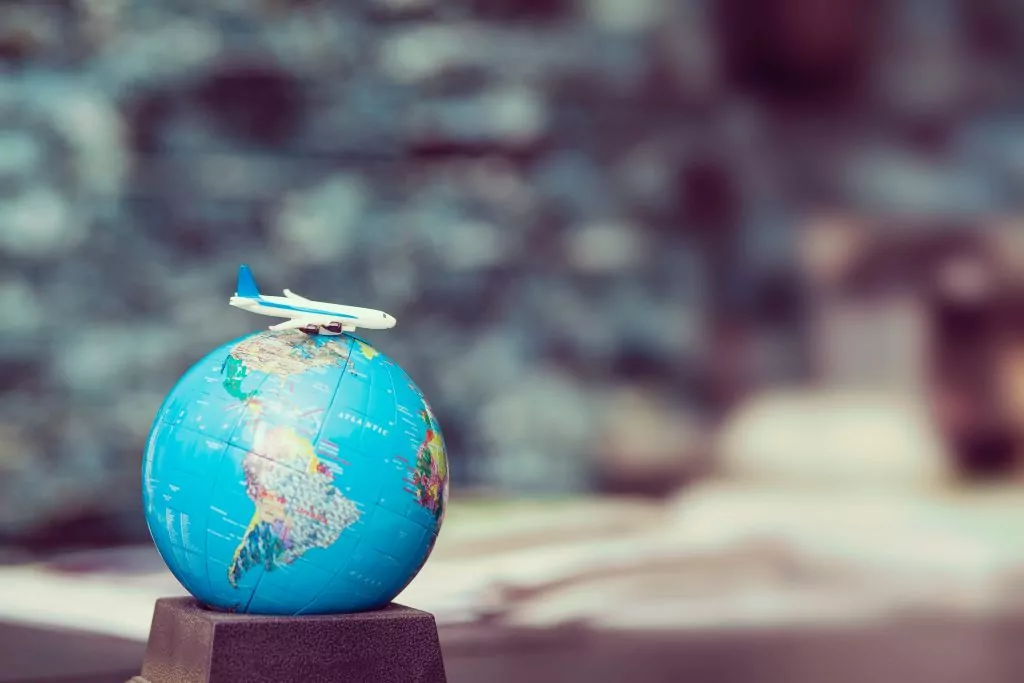 world map with plane on top